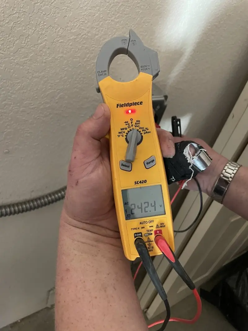Voltage testing with clamp meter during Recessed Lighting Installation in Delmar